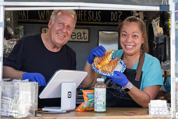 Food truck owners of What Would Cheesus Do, serving the spectators at the Erie Balloon Festival.
